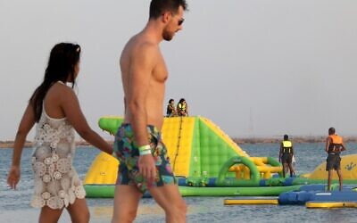 Beachgoers play at floating blow-up water park, at Pure Beach in King Abdullah Economic City, Saudi Arabia, on September 17, 2021 (Fayez NURELDINE / AFP)