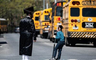 Illustrative image: School buses lined up in the Williamsburg neighborhood of Brooklyn on April 24, 2019. (Johannes Eisele/AFP via Getty Images/JTA)