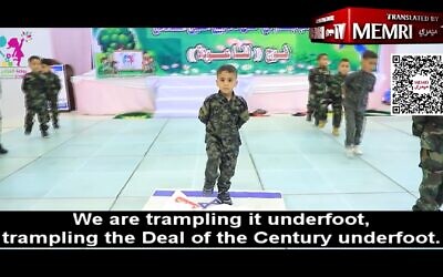 A Gazan preschooler stomps on an Israeli flag at a graduation ceremony, at the Young Deer Kindergarten in Beit Hanoun, in footage posted from May 24 - May 27, 2023. (MEMRI screenshot)