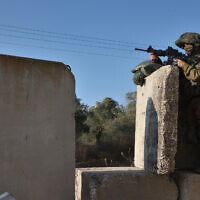 Illustrative: An Israeli soldier mans the Reihan checkpoint near the Israeli settlement of the same name, near Jenin in the West Bank on June 22, 2023. (GIL COHEN-MAGEN / AFP)