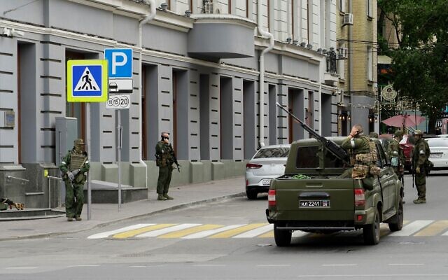 Members of the mercenary Wagner Group stand guard in a street in the Russian city of Rostov-on-Don, on June 24, 2023. (Stringer/AFP)