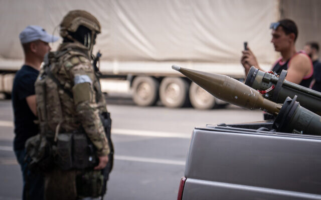 This photograph taken on June 24, 2023, shows two grenade launchers in a car as local residents pose for a photograph with a member of the Wagner group in the Russian city of Rostov-on-Don. (Roman Romokhov/AFP)