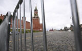 The Spasskaya Tower is seen through metal barriers at Moscow's Red Square on June 24, 2023. (Natalia Kolesnikova/AFP)