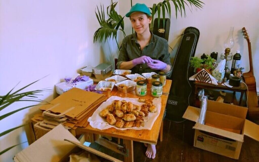 Joe Isaac packs Pink Peacock food for delivery. (Pink Peacock/ via JTA)