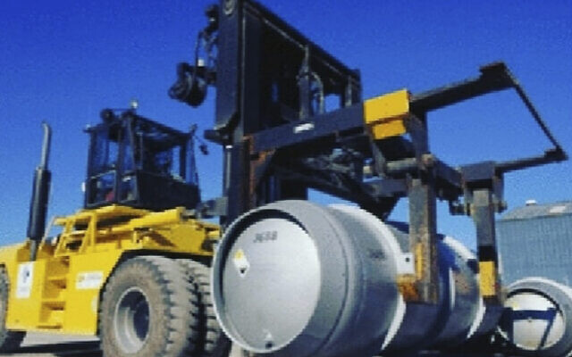 A lift truck carries a cylinder containing uranium hexafluoride gas for the purpose of injecting the gas into centrifuges in Iran's Fordo nuclear facility, November 6, 2019. (Atomic Energy Organization of Iran via AP)