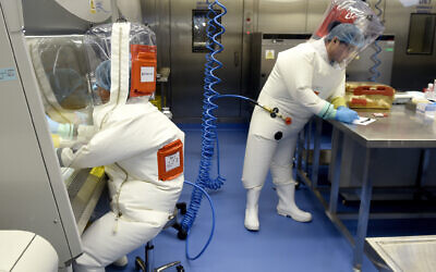 In this photo taken Thursday, February 23, 2017, researchers work in a lab of the Wuhan Institute of Virology in Wuhan in central China's Hubei province. (Chinatopix/AP)