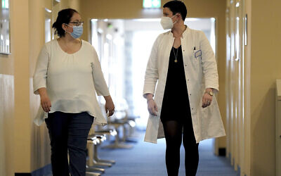 Illustrative image: A patient (left) and a doctor in Heiligendamm, northern Germany, at one of many clinics around the world that specialises in care and rehab for people with long COVID, April 14, 2021. (AP Photo/Michael Sohn)