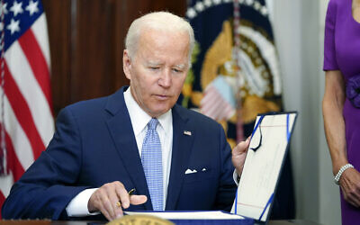 US President Joe Biden signs into law S. 2938, the Bipartisan Safer Communities Act gun safety bill, in the Roosevelt Room of the White House in Washington, June 25, 2022. (AP Photo/Pablo Martinez Monsivais)