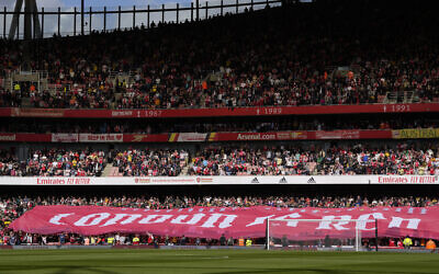 Fans attend the start of the English Premier League soccer match between Arsenal and Tottenham Hotspur, at Emirates Stadium, in London, England, October 1, 2022. (AP Photo/Kirsty Wigglesworth)