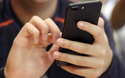 Illustration photo: A person uses a smart phone in Chicago for online shopping, including travel shopping, which has shifted from desktop to mostly mobile devices. (AP Photo)