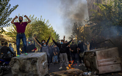 In this photo taken by an individual not employed by the Associated Press and obtained by the AP outside Iran, Iranians protests the death of 22-year-old Mahsa Amini after she was detained by the morality police while in custody, in Tehran, October 27, 2022. (Middle East Images/AP)