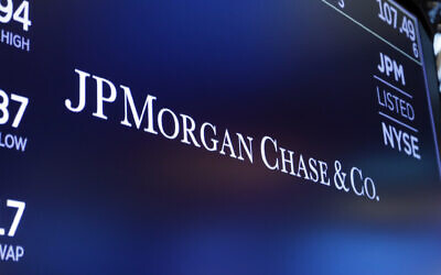 In this August 16, 2019, file photo, the logo for JPMorgan Chase & Co. appears above a trading post on the floor of the New York Stock Exchange in New York. (AP Photo/Richard Drew)