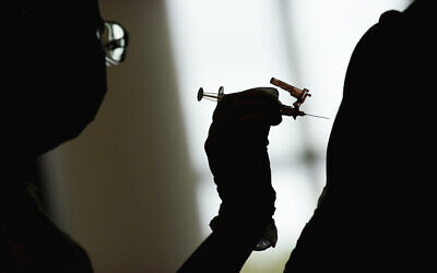 A nursing student administers the Moderna COVID-19 vaccine at a vaccination center at UNLV, in Las Vegas, April 26, 2021. (AP Photo/John Locher, File)