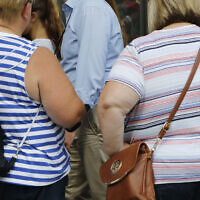 Two women stand on August 16, 2016, in New York. High body mass index -- an indication that people could be overweight -- was linked to more than half of deaths and disability from diabetes. (AP Photo/Mark Lennihan, File)