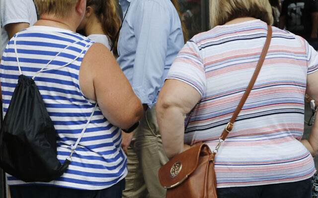 Two women stand on August 16, 2016, in New York. High body mass index -- an indication that people could be overweight -- was linked to more than half of deaths and disability from diabetes. (AP Photo/Mark Lennihan, File)