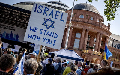 A woman holds a sign as she takes part in a protest against a Roger Waters concert later in the day in the Festhalle, Frankfurt, Germany, May 28, 2023. (AP Photo/Michael Probst)