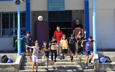 Palestinian boys jump during a soccer training session at a school run by the agency for Palestinian refugees, or UNRWA, at Ein el-Hilweh Palestinian refugee camp, in the southern port city of Sidon, Lebanon, Tuesday, June 20, 2023. (AP Photo/Mohammed Zaatari)