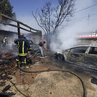 Palestinian firefighters try to extinguish a fire set by settlers in the West Bank town of Turmus Ayya, Wednesday, June 21, 2023.  (AP Photo/Majdi Mohammed)