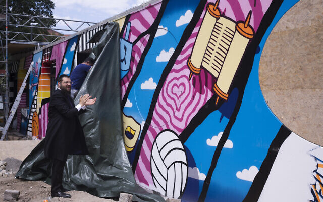 Rabbi Yehuda Teichtal attends the unveiling of a graffiti wall at the entrance of the new Jewish educational and cultural complex in Berlin, Germany, June 12, 2023. (AP Photo/Markus Schreiber)