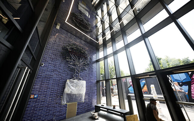 A 'Tree of Life' installation covers a wall at the entrance of the new Jewish educational and cultural complex in Berlin, Germany, June 22, 2023. (AP Photo/Markus Schreiber)