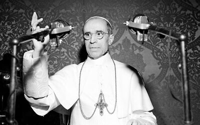 Pope Pius XII appears behind microphones during a radio broadcast from the Vatican in November 1947.  The Pope commended the American people for their efforts to save food for war-torn Europe.  (AP Photo/Luigi Felici)