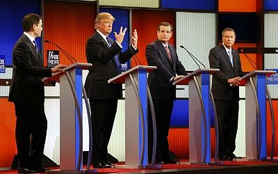 Republican presidential candidate Donald Trump, second from left, gestures as Sen. Marco Rubio, R-Florida, Sen. Ted Cruz, R-Texas, and Ohio Gov. John Kasich watch him in the Republican presidential primary debate at Fox Theatre in Detroit, Michigan, Thursday, March 3, 2016. (AP Photo/Paul Sancya)