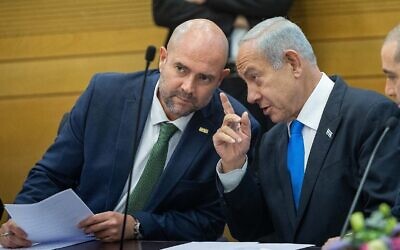 Prime Minister Benjamin Netanyahu , right, converses with Knesset Speaker Amir Ohana during a Likud faction meeting on February 6, 2023. (Yonatan Sindel/Flash90)