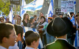 Israelis attend a protest against military service exemptions for ultra-Orthodox yeshiva students and the government's planned judicial overhaul, outside the Kol Torah yeshiva in Jerusalem, May 4, 2023. (Noam Revkin Fenton/Flash90)