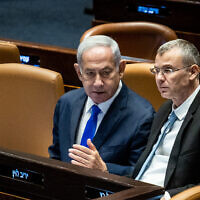 Prime Minister Benjamin Netanyahu (L) with Justice Minister Yariv Levin at the Knesset in Jerusalem, on June 7, 2023. (Oren Ben Hakoon/Flash90)