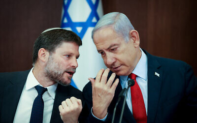 Prime Minister Benjamin Netanyahu speaks with Finance Minister Bezalel Smotrich during the cabinet meeting at the Prime Minister's Office in Jerusalem on June 18, 2023. (Amit Shabi/POOL)