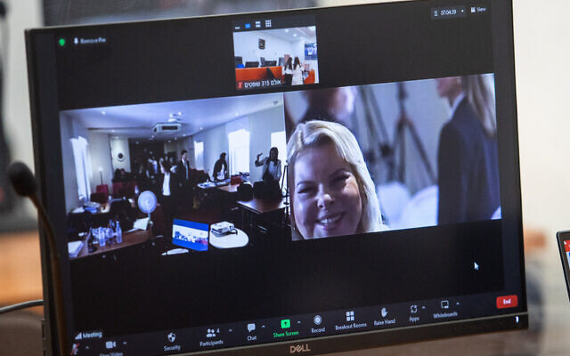 Sara Netanyahu, in the United Kingdom for the testimony of Arnon Milchan in Prime Minister Benjamin Netanyahu's corruption trial, is seen on a screen at the Jerusalem District Court on June 25, 2023 (Oren Ben Hakoon/POOL )