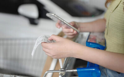 A woman checks the bill at a supermarket. (M Stock, iStock photos at Getty Images)