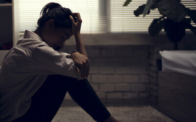 Illustrative: A young woman sits alone (torwai; iStock by Getty Images)