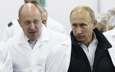 In this Monday, September 20, 2010 file photo, Yevgeny Prigozhin, left, shows Russian President Vladimir Putin, around his factory which produces school meals, outside St. Petersburg, Russia. (Alexei Druzhinin, Sputnik, Kremlin Pool Photo via AP, File)